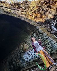 High angle view of man sitting on rock