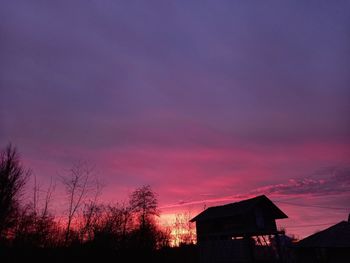 Silhouette buildings against sky during sunset