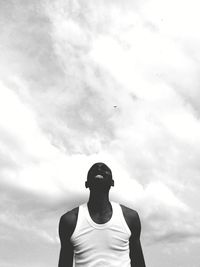 Low angle view of man standing against sky