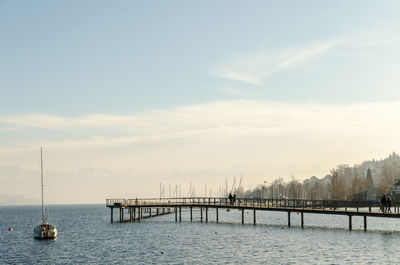 Bridge over sea against sky