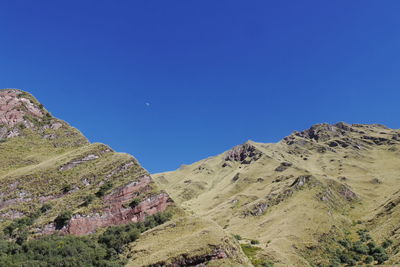 Scenic view of mountains against clear blue sky