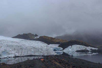 Scenic view of lake against sky during winter