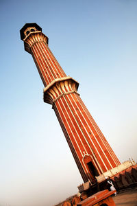 Low angle view of historic column against clear blue sky