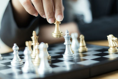 Close-up of man playing with chess