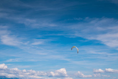 Parachute of the kitesurfer against blue sky. clouds on the sky.