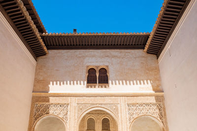 Low angle view of a building against blue sky