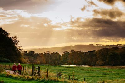 Scenic view of grassy field against cloudy sky