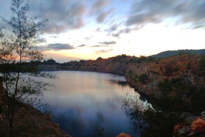 Scenic view of river against sky at dusk