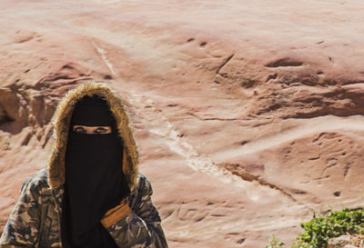 Portrait of person standing in desert