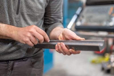 Midsection of man using mobile phone