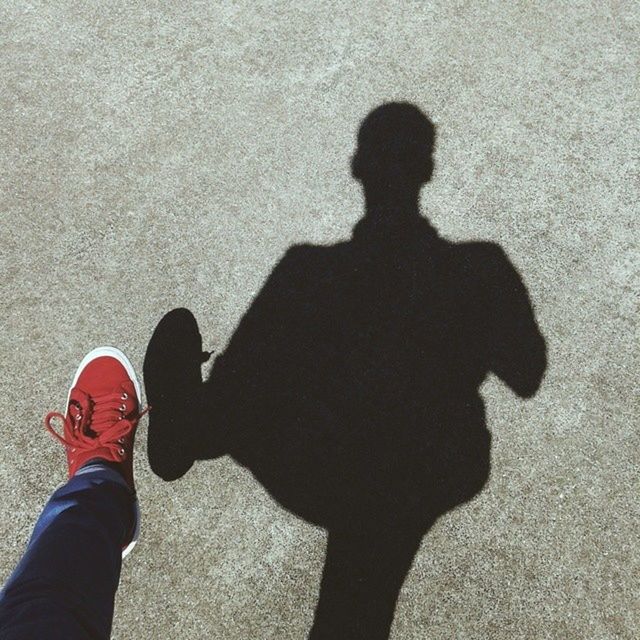 shadow, standing, lifestyles, high angle view, silhouette, personal perspective, leisure activity, focus on shadow, low section, person, shoe, street, men, sunlight, unrecognizable person, outdoors, outline