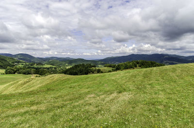 Scenic view of landscape against cloudy sky