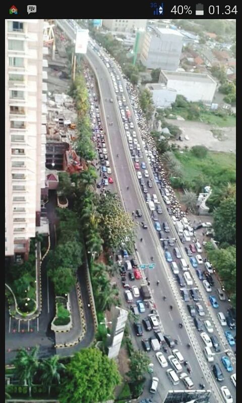 transportation, transfer print, car, high angle view, city, road, street, land vehicle, auto post production filter, building exterior, traffic, built structure, architecture, mode of transport, tree, diminishing perspective, city life, the way forward, road marking, city street