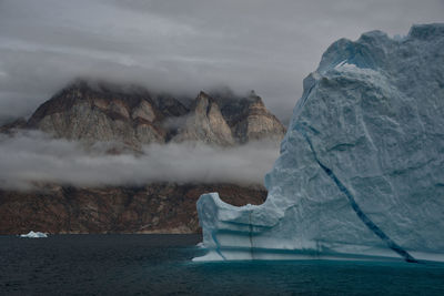 Scenic view of frozen sea against cloudy sky during winter