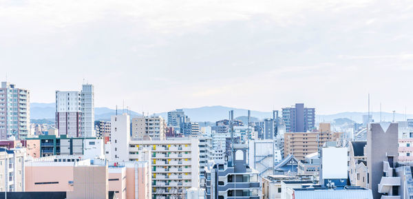 Modern buildings in city against sky