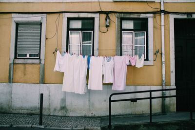 Clothes drying on clothesline against building