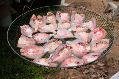 Fresh fish in a basket put to dry in the sun. thai food preservation.