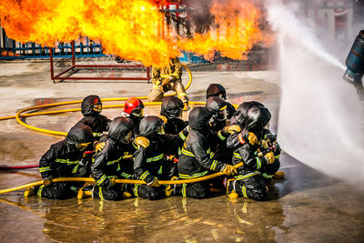 Firefighter spraying water on fire