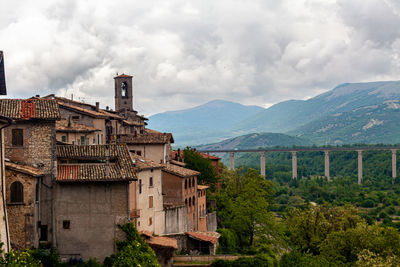 Bridge over mountains against sky