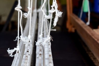 Close-up of icicles hanging on wood in winter