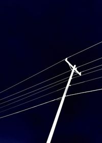 Low angle view of illuminated vapor trail against sky at night