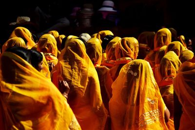 Rear view of women wearing yellow sari