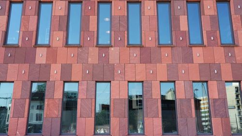 Facade of mas museum with reflections in the windows of the neighborhood