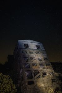 Low angle view of old building against sky at night