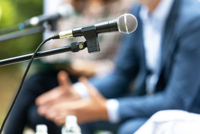 Microphone in focus at round table event or business conference. public speaking concept.