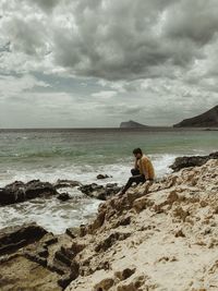 Scenic view of rocks on beach against sky