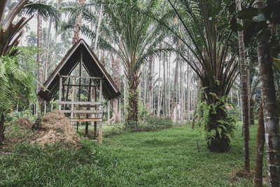 Built structure by trees on field