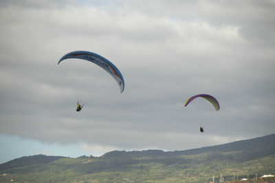 People paragliding against sky