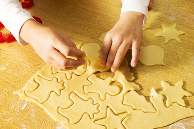 Happy children  making cookies in christmas bakery in home kitchen