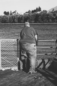 Rear view of man standing against trees