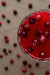 High angle view of red berries in glass