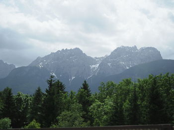 Scenic view of mountains against cloudy sky