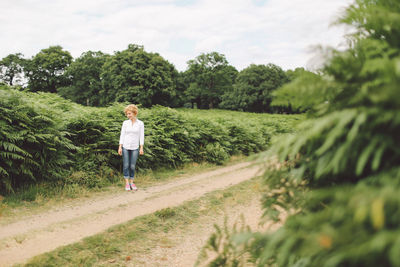 Young woman standing on road