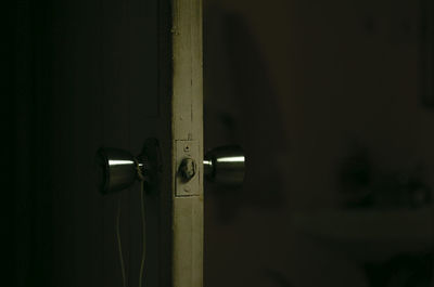 Close-up of door handles in darkroom