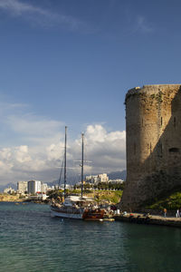 Sailboats in sea against sky