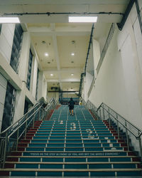 Low angle view of a male climbing a staircase 