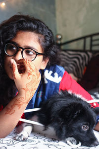 Portrait of woman with dog sitting at home