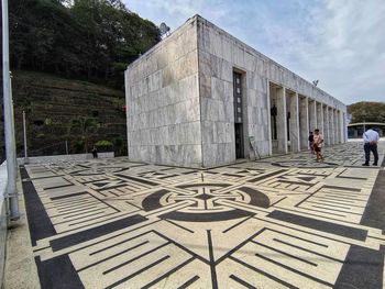 People walking in front of historical building