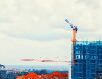 Cranes at construction site against sky in city nairobi 