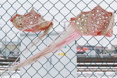 Close-up of decoration hanging on chainlink fence