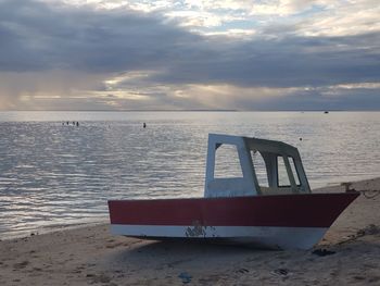 Lifeguard hut on beach against sky during sunset