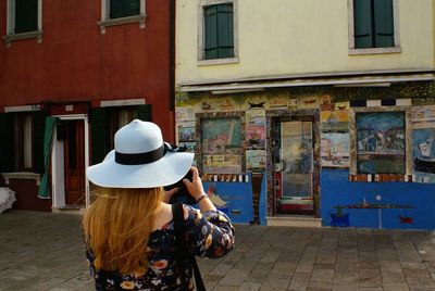 Rear view of woman standing on street