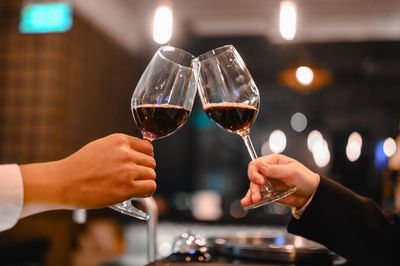 Close-up of hand holding glass of wine