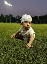 Portrait of girl standing on grassy field