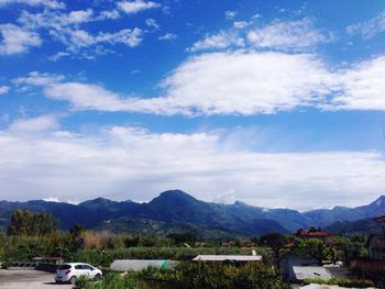 Scenic view of mountains against blue sky