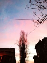 Low angle view of built structure against sky at sunset